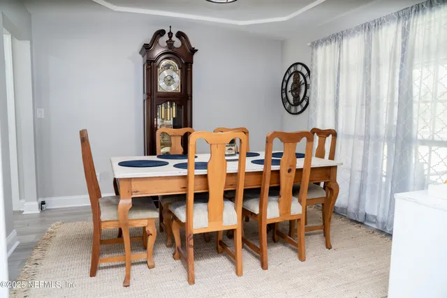 a dining room with furniture and window
