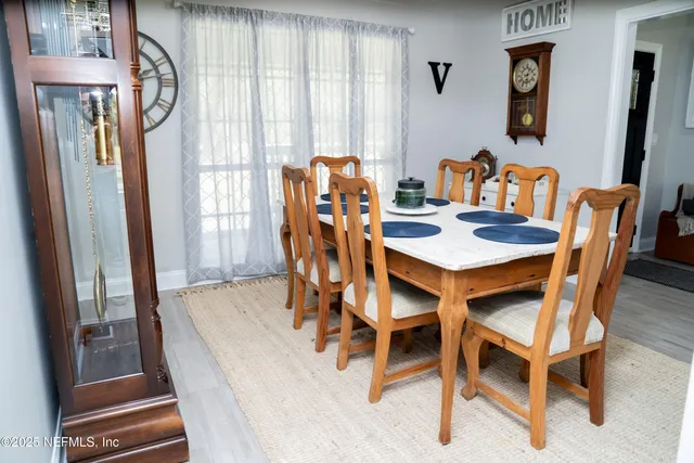 a dining room with furniture and window