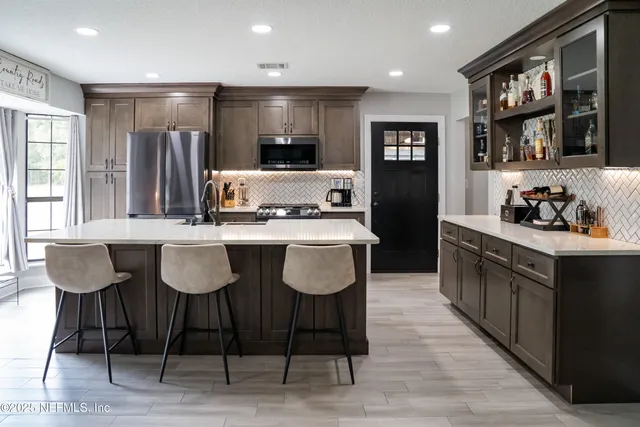 a kitchen with stainless steel appliances granite countertop a stove and a refrigerator