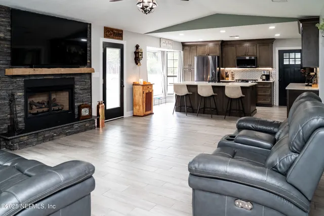 a living room with furniture a couch and a ceiling fan