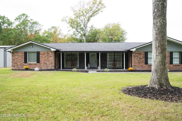 a front view of a house with a garden and patio