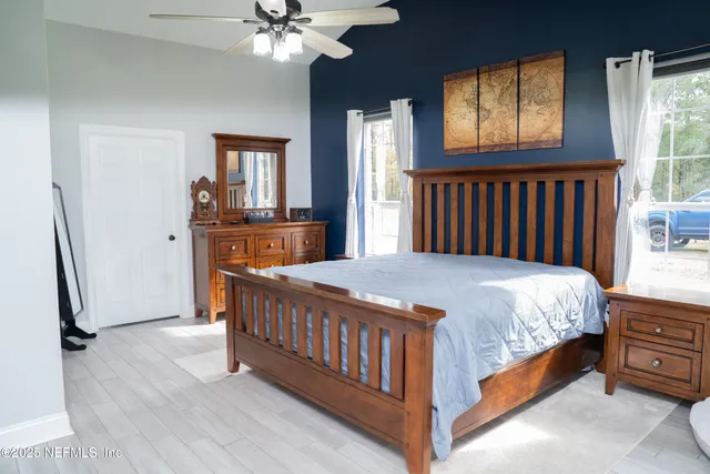 a bedroom with a bed next to a window