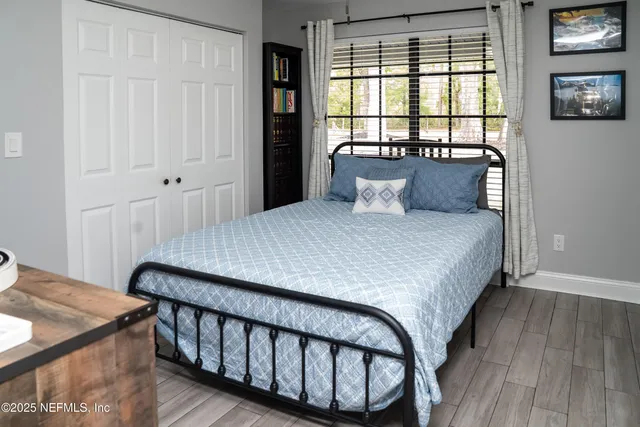 a bedroom with a bed and flat screen tv
