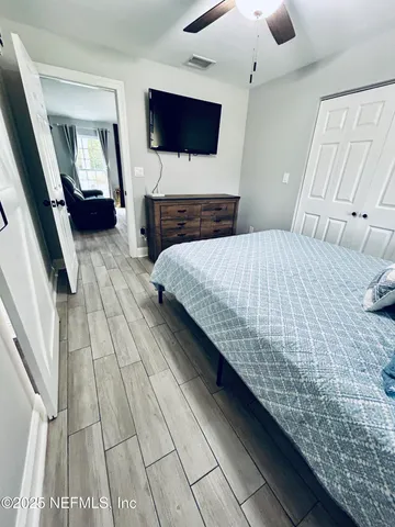 a bed sitting in a bedroom next to a window