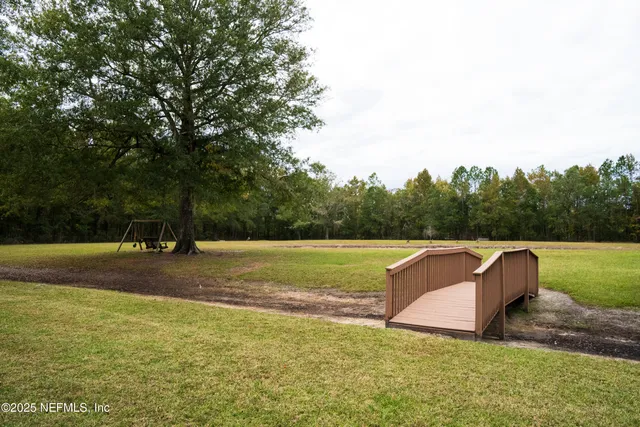 a house view with a swimming pool and sitting area
