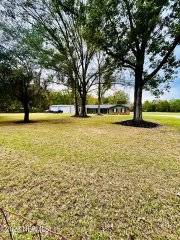 a view of outdoor space with deck and trees