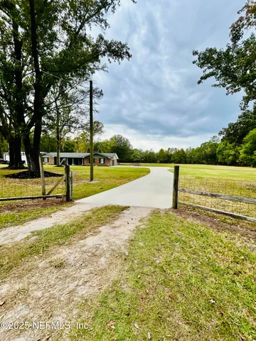 an aerial view of residential houses with outdoor space and seating area
