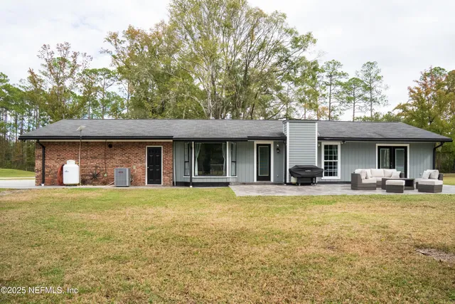 a view of a house with swimming pool and sitting area