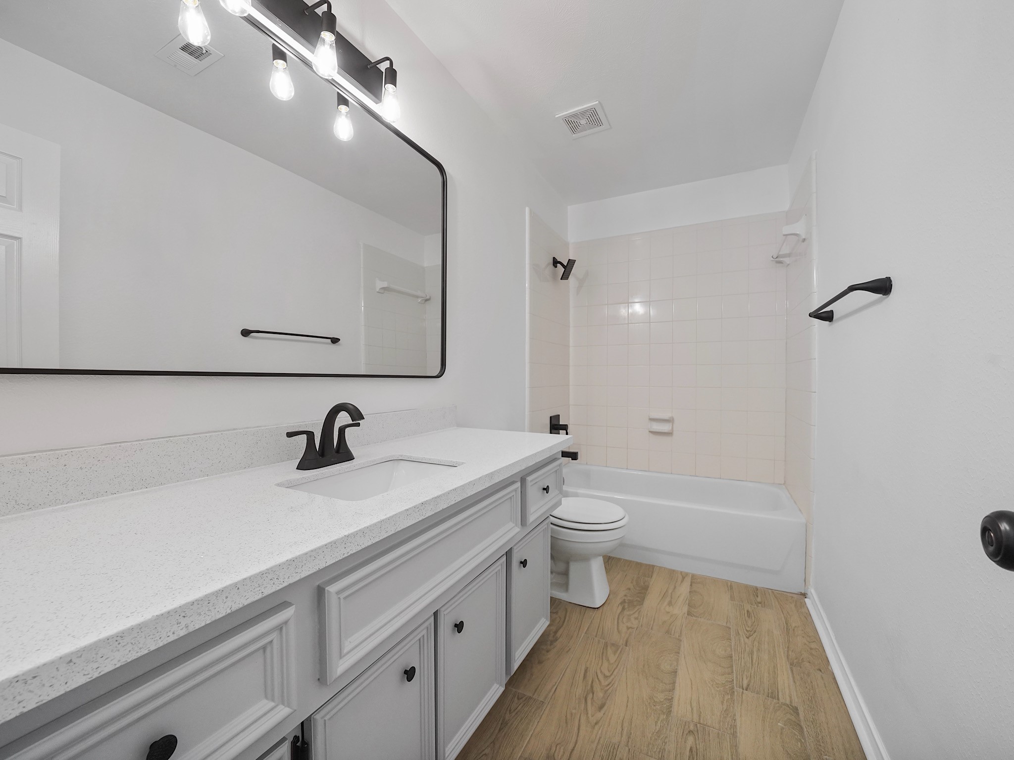 14206 Windy Ridge Lane Rosharon, TX 77583 - Photo 13 of 15 Experience modern elegance in Bathroom 2, featuring a stylish new mirror, upgraded fixtures, sleek countertops, and beautiful flooring.