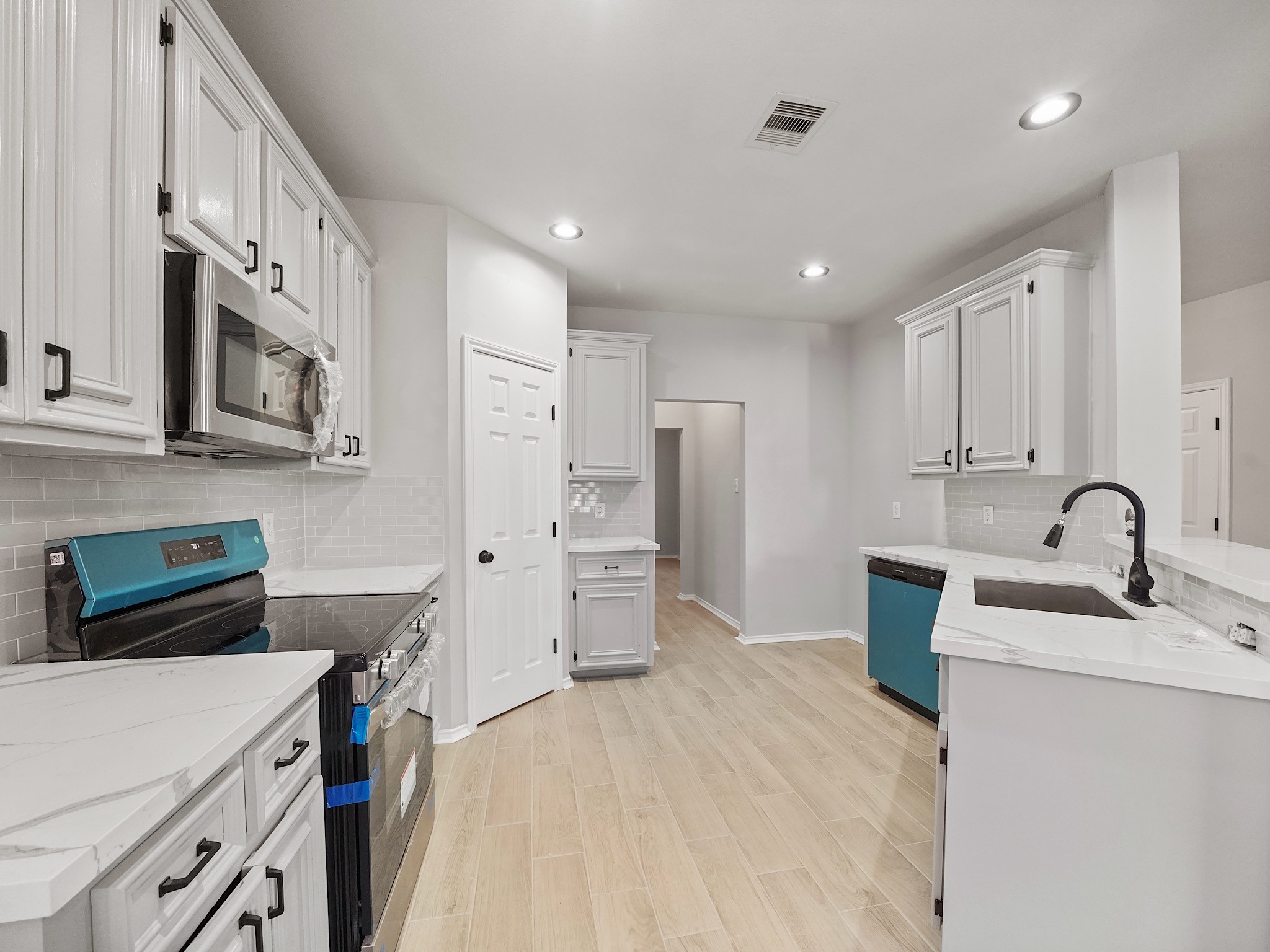 14206 Windy Ridge Lane Rosharon, TX 77583 - Photo 5 of 15 Modern kitchen with brand-new stove, microwave, and dishwasher.