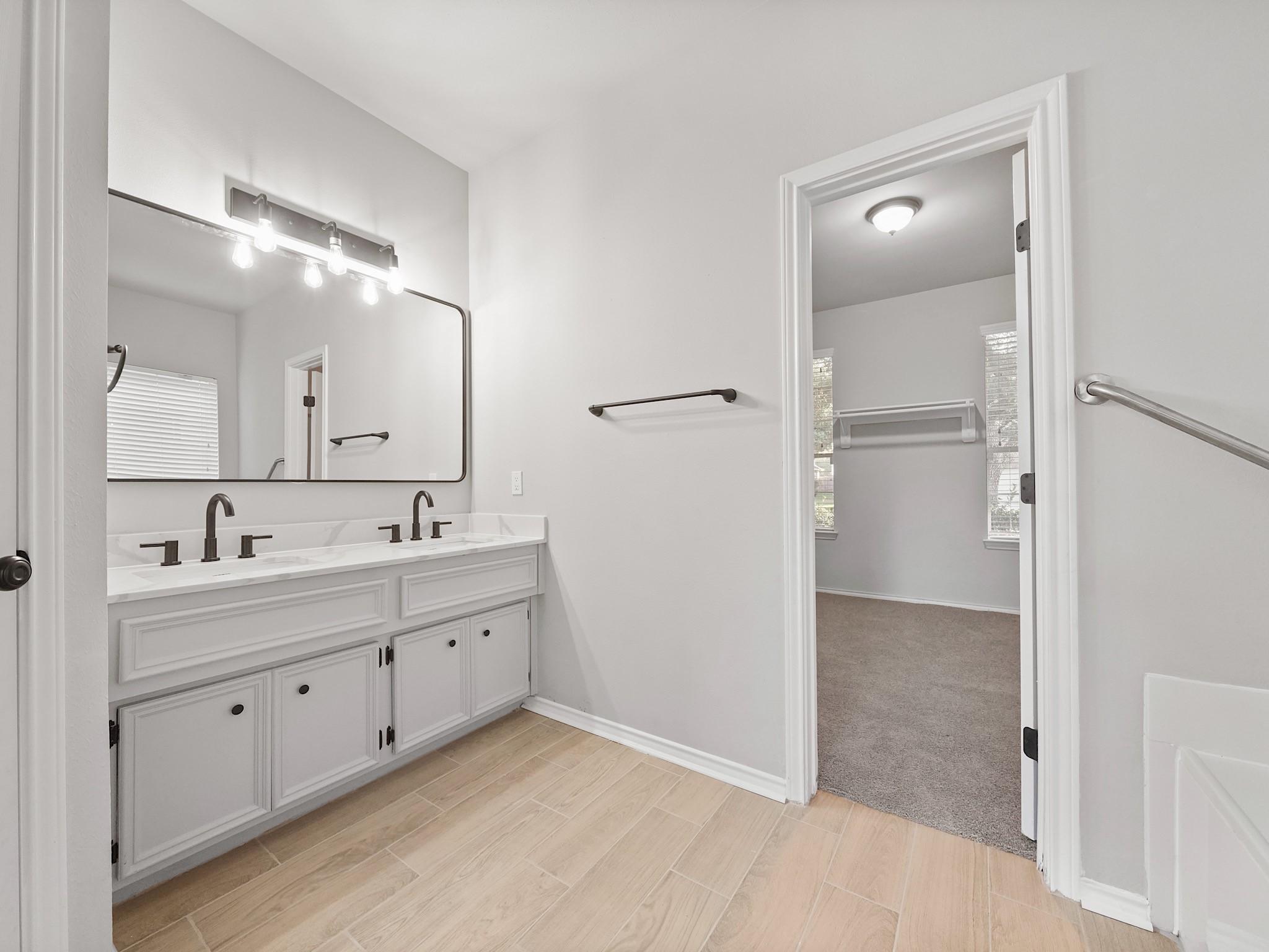 14206 Windy Ridge Lane Rosharon, TX 77583 - Photo 8 of 15 Experience a fresh modern upgrade with brand-new mirrors, countertops, sinks, and flooring in the bathrooms.