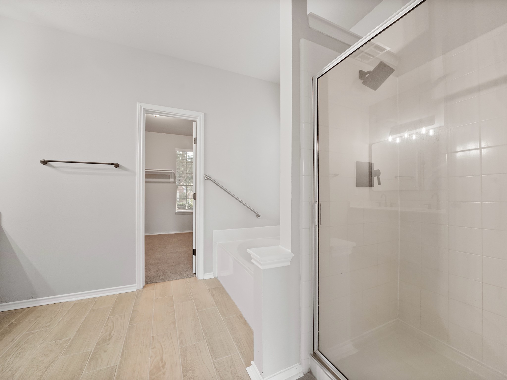 14206 Windy Ridge Lane Rosharon, TX 77583 - Photo 9 of 15 Enjoy the luxury of a separate tub and shower, complemented by brand-new flooring in the primary bathroom.