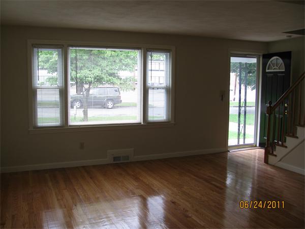 149 Wheeler Avenue Springfield, MA 01118 - Photo 5 of 6 an empty room with wooden floor and windows