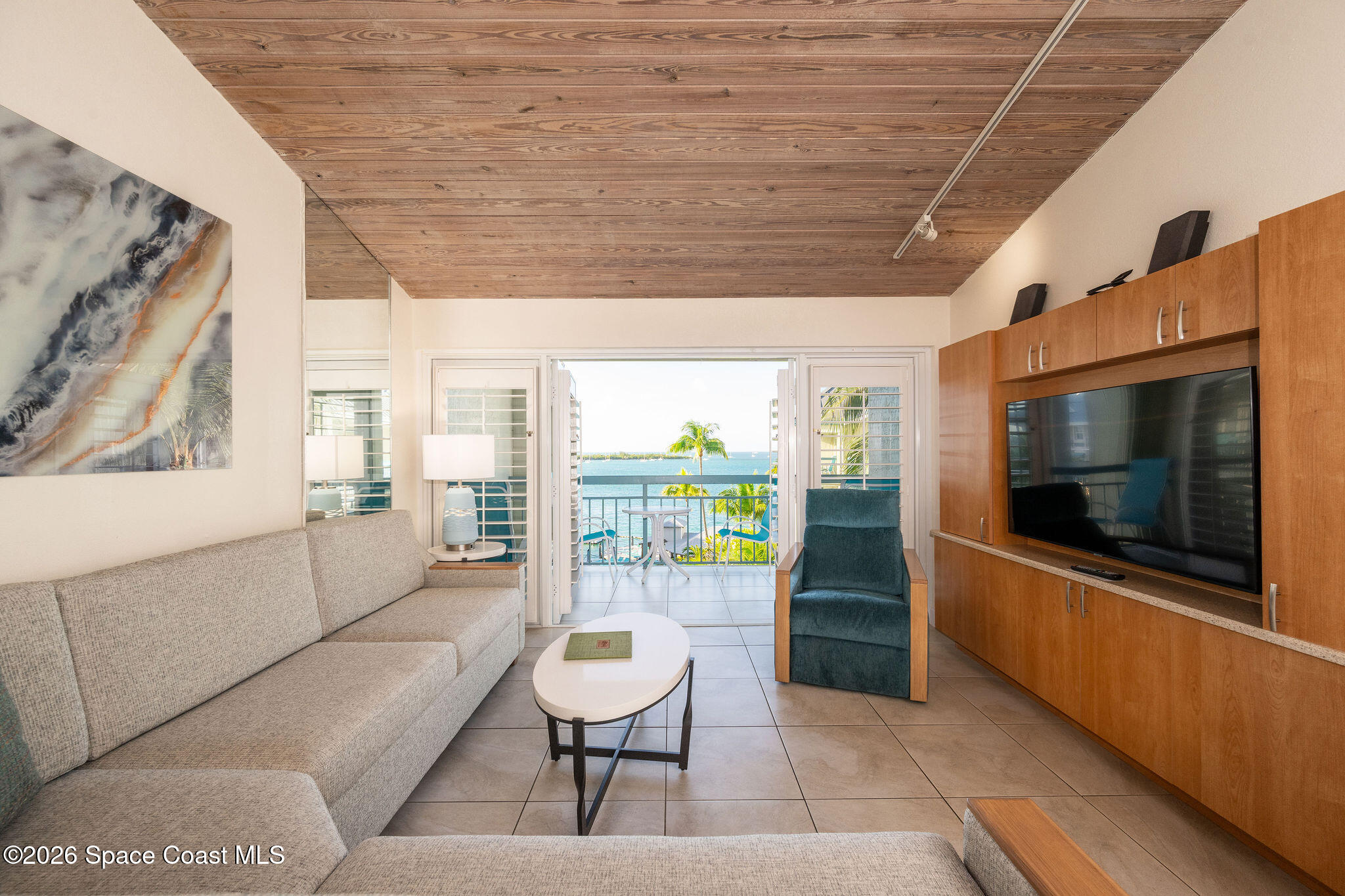 617 Front Street, Unit B51 Key West, FL 33040 - Photo 4 of 56 a living room with furniture a flat screen tv and a floor to ceiling window