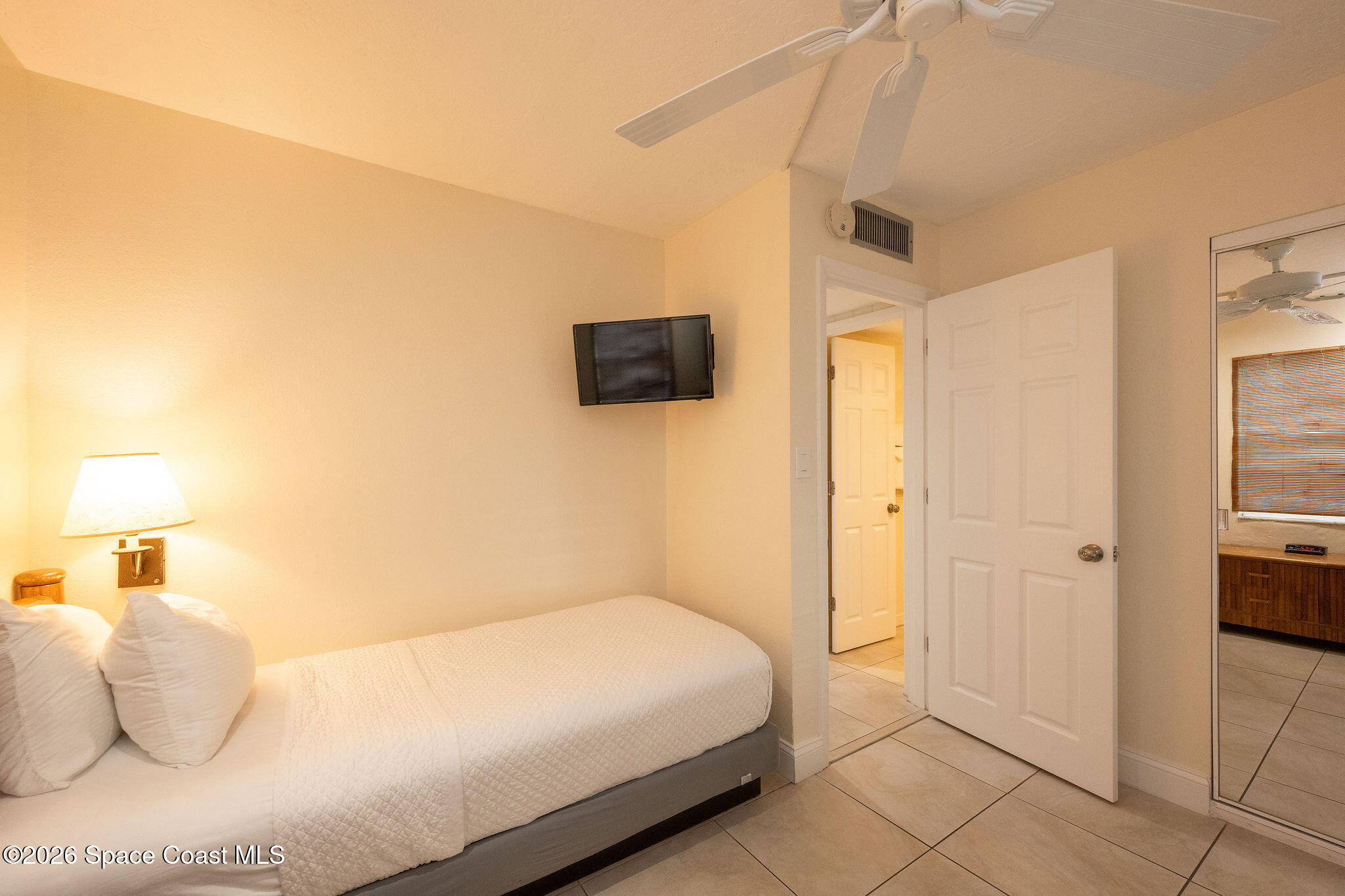 617 Front Street, Unit B51 Key West, FL 33040 - Photo 41 of 56 a bedroom with a bed and a flat screen tv