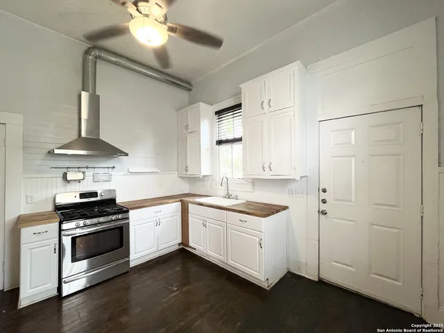 a kitchen with stainless steel appliances a sink and a stove