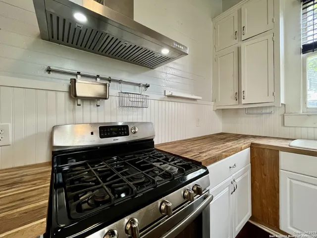 a stove top oven sitting inside of a kitchen