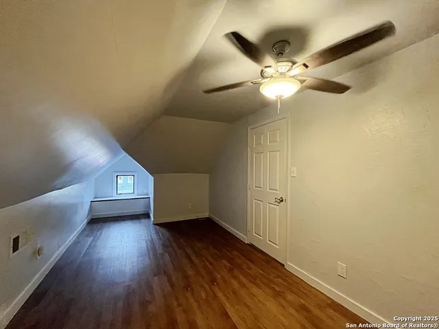 a view of an empty room and wooden floor