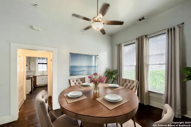 a view of a dining room with furniture and a chandelier