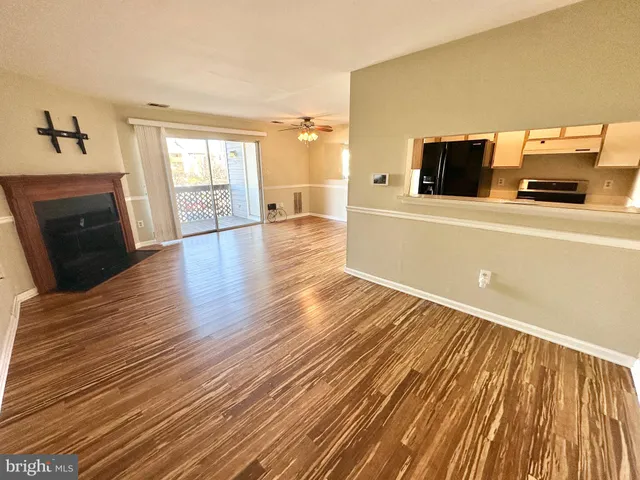a view of a livingroom with wooden floor and fireplace