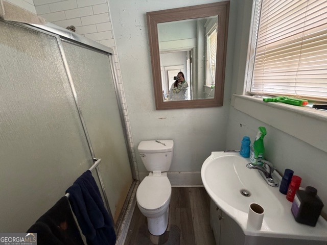 312 Grady Avenue Northeast Rome, GA 30161 - Photo 8 of 12 a white toilet sitting next to a bathroom sink