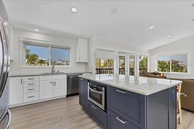 a kitchen with stainless steel appliances granite countertop a stove and a sink