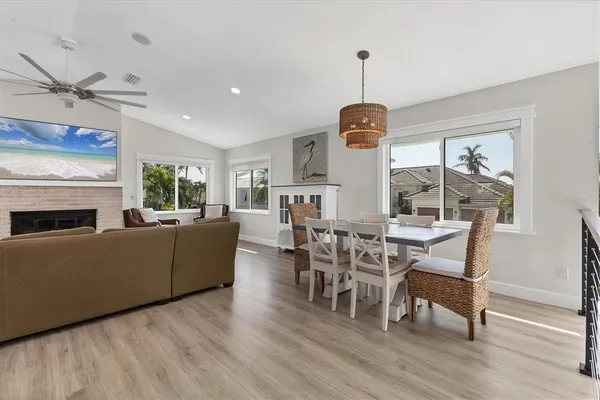 a living room with furniture a dining table and a fireplace