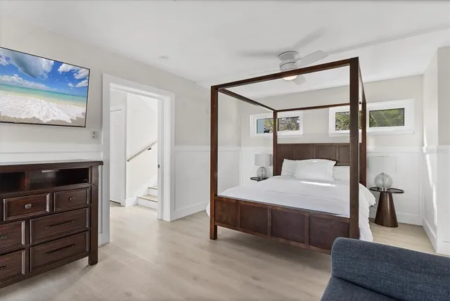 a bedroom with a bed and a mirror on dresser