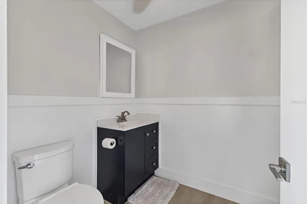 a bathroom with a toilet and mirror