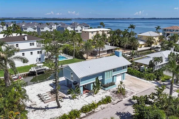 an aerial view of a house with yard swimming pool and outdoor seating