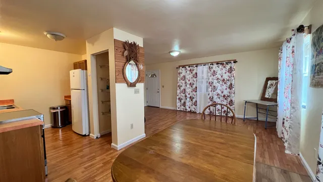 a view of a room with furniture and wooden floor