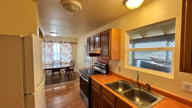 a kitchen that has a sink and a stove in it