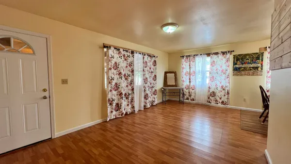 a view of a livingroom with hardwood and furniture