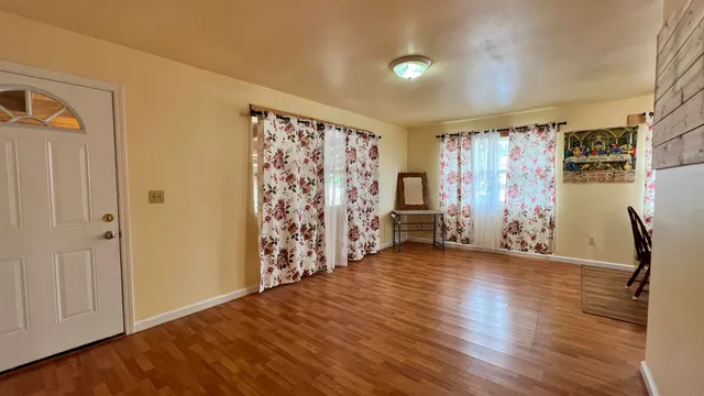 a view of a livingroom with hardwood and furniture