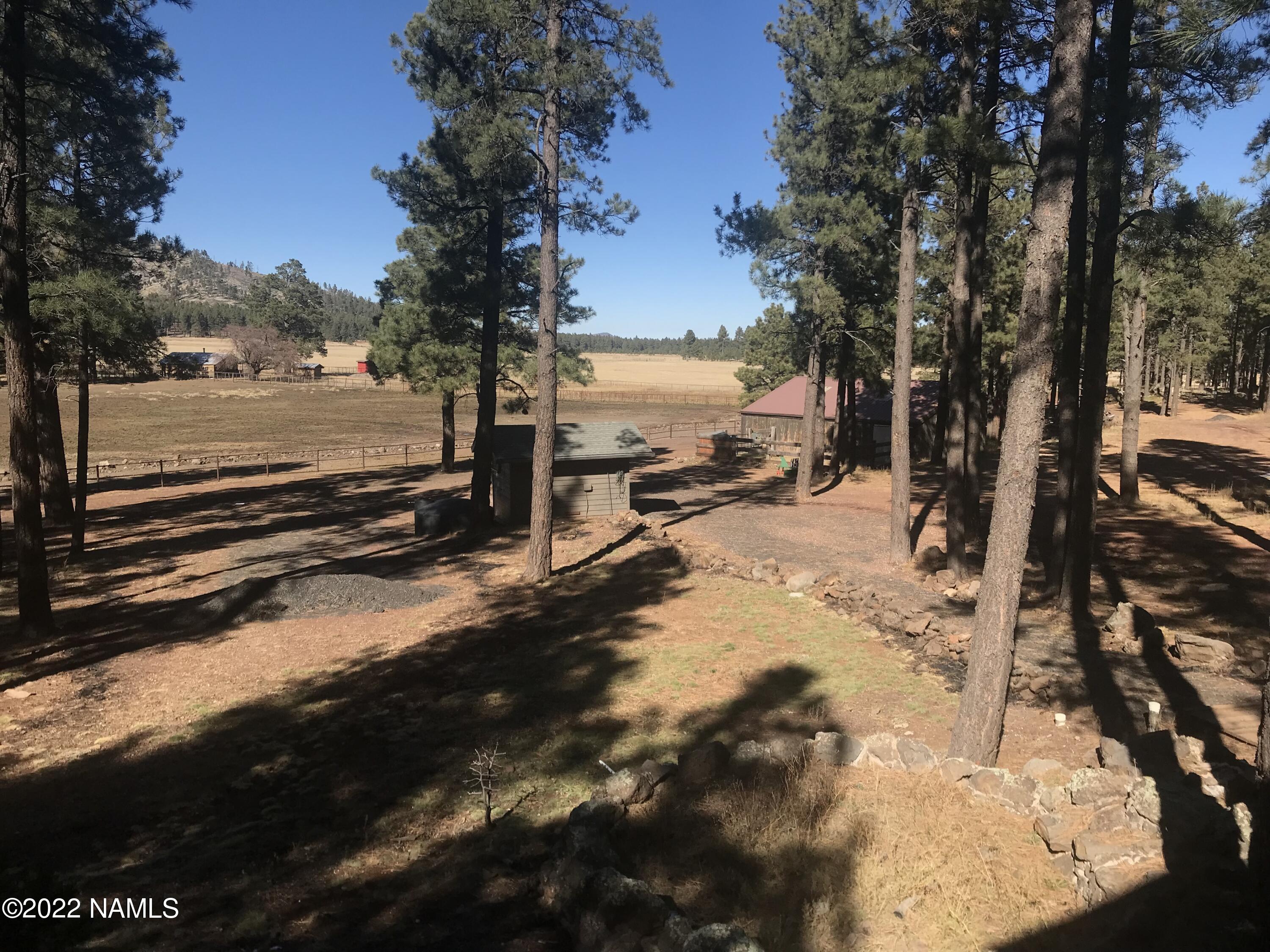 12830 East Thunder Rdg Road Parks, AZ 86018 - Photo 20 of 97 a view of a yard with wooden fence