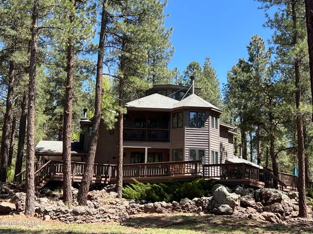 a front view of a house with a tree