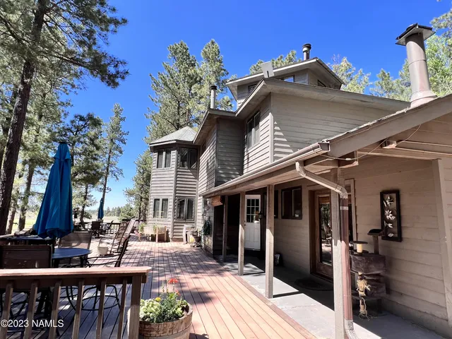 a view of a yard with wooden fence