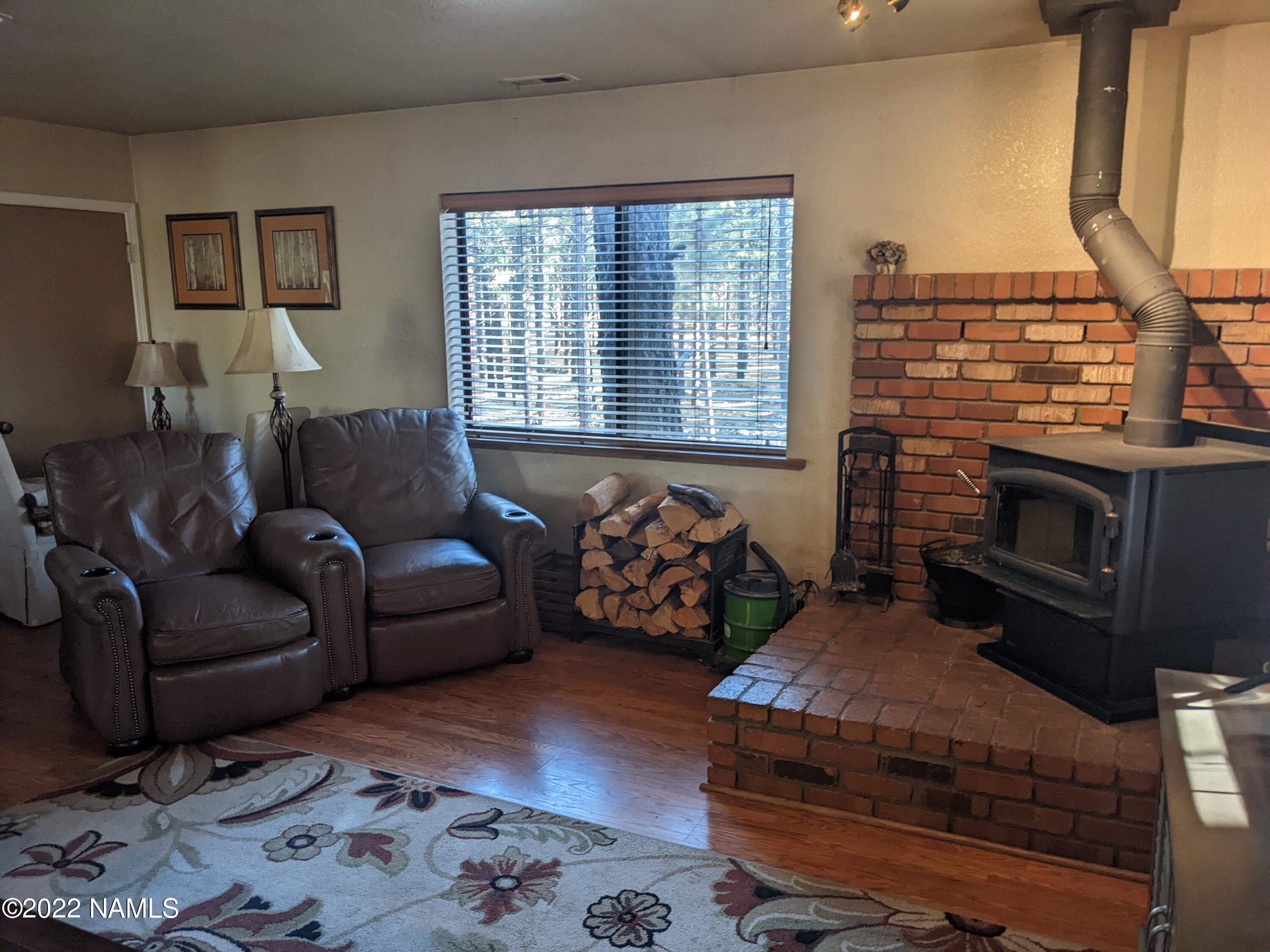 12830 East Thunder Rdg Road Parks, AZ 86018 - Photo 62 of 97 a living room with furniture fireplace and a flat screen tv