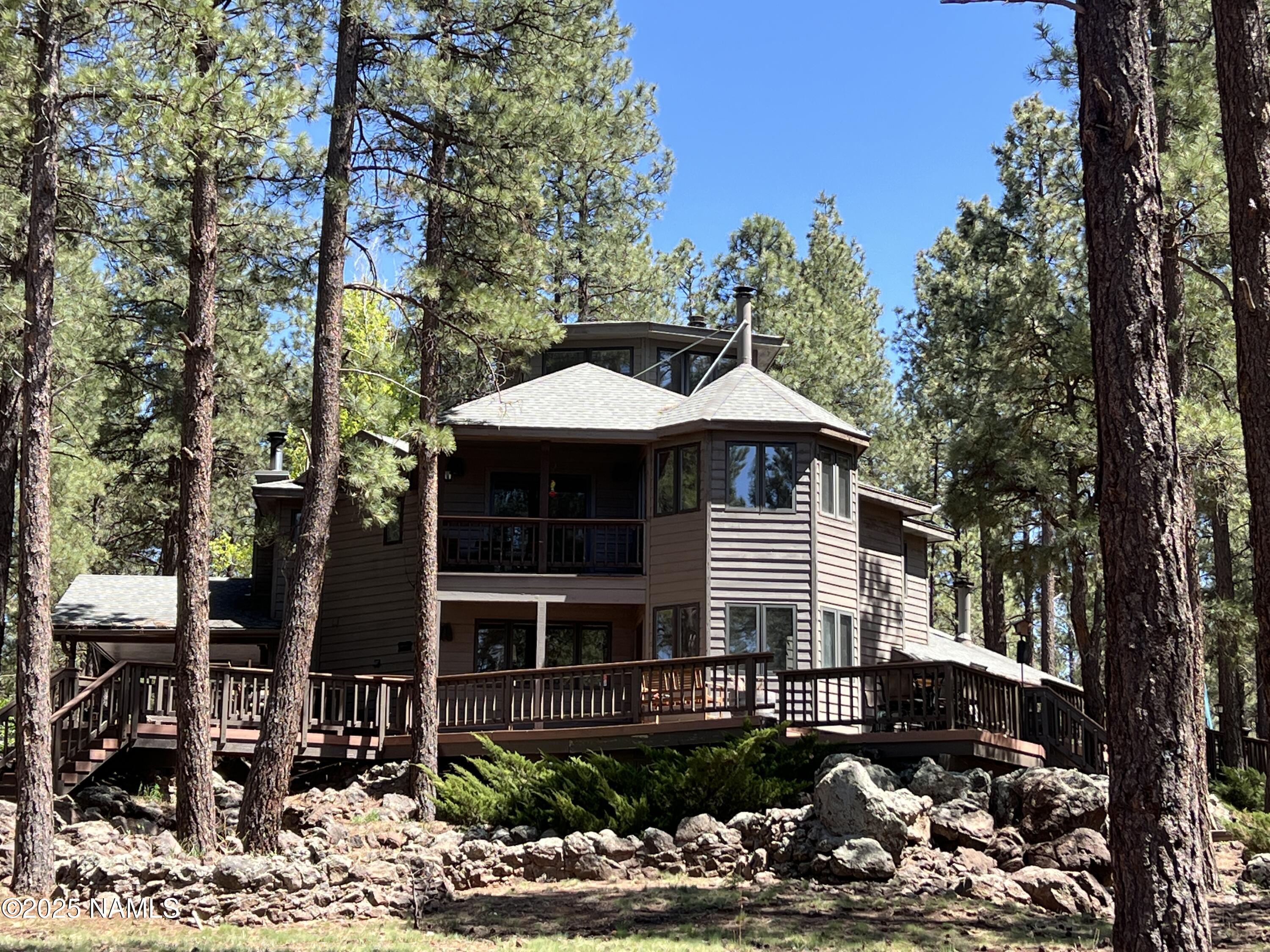 12830 East Thunder Rdg Road Parks, AZ 86018 - Photo 97 of 97 a front view of a house with garden