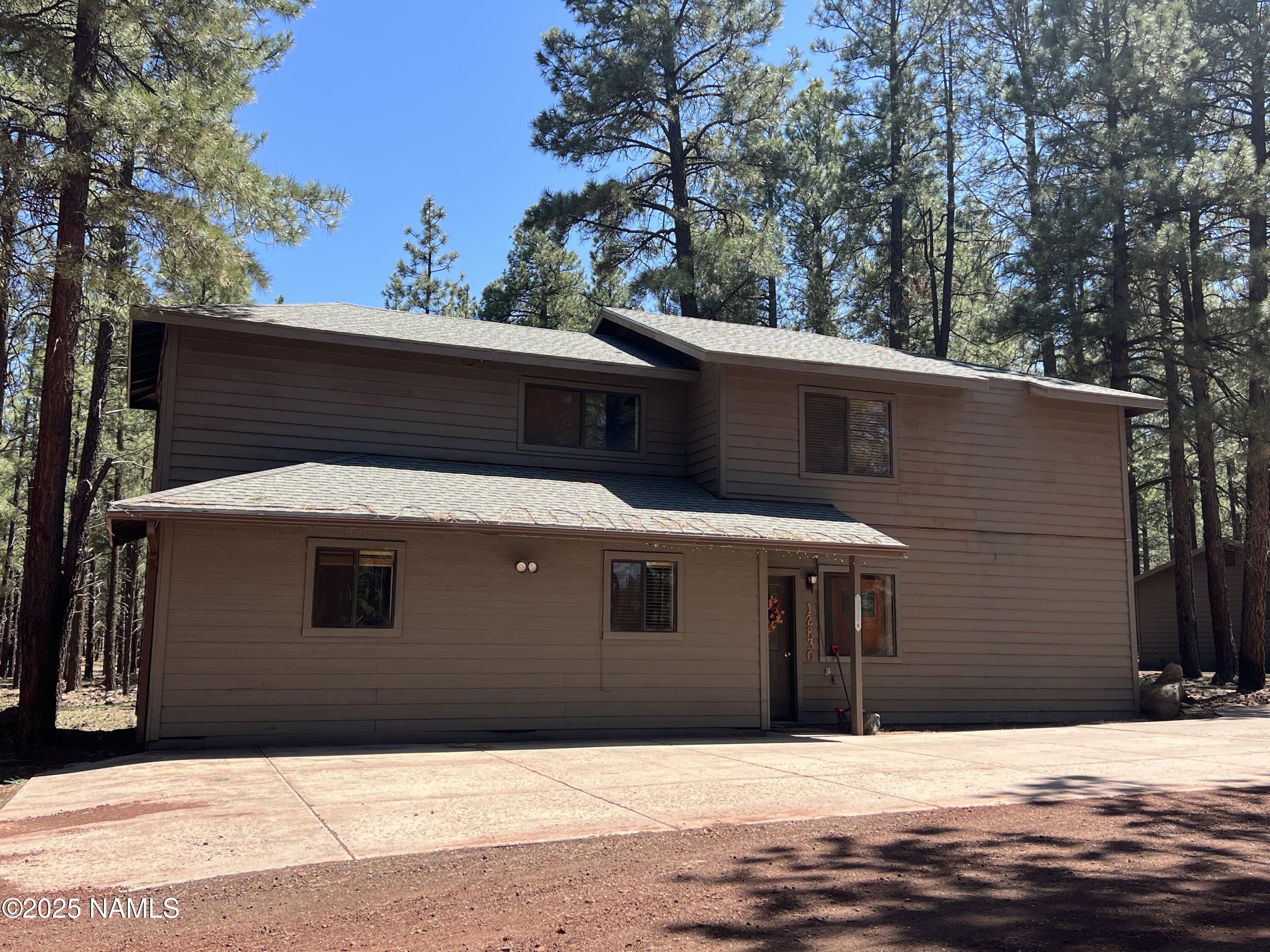 12830 East Thunder Rdg Road Parks, AZ 86018 - Photo 10 of 97 a front view of a house with yard