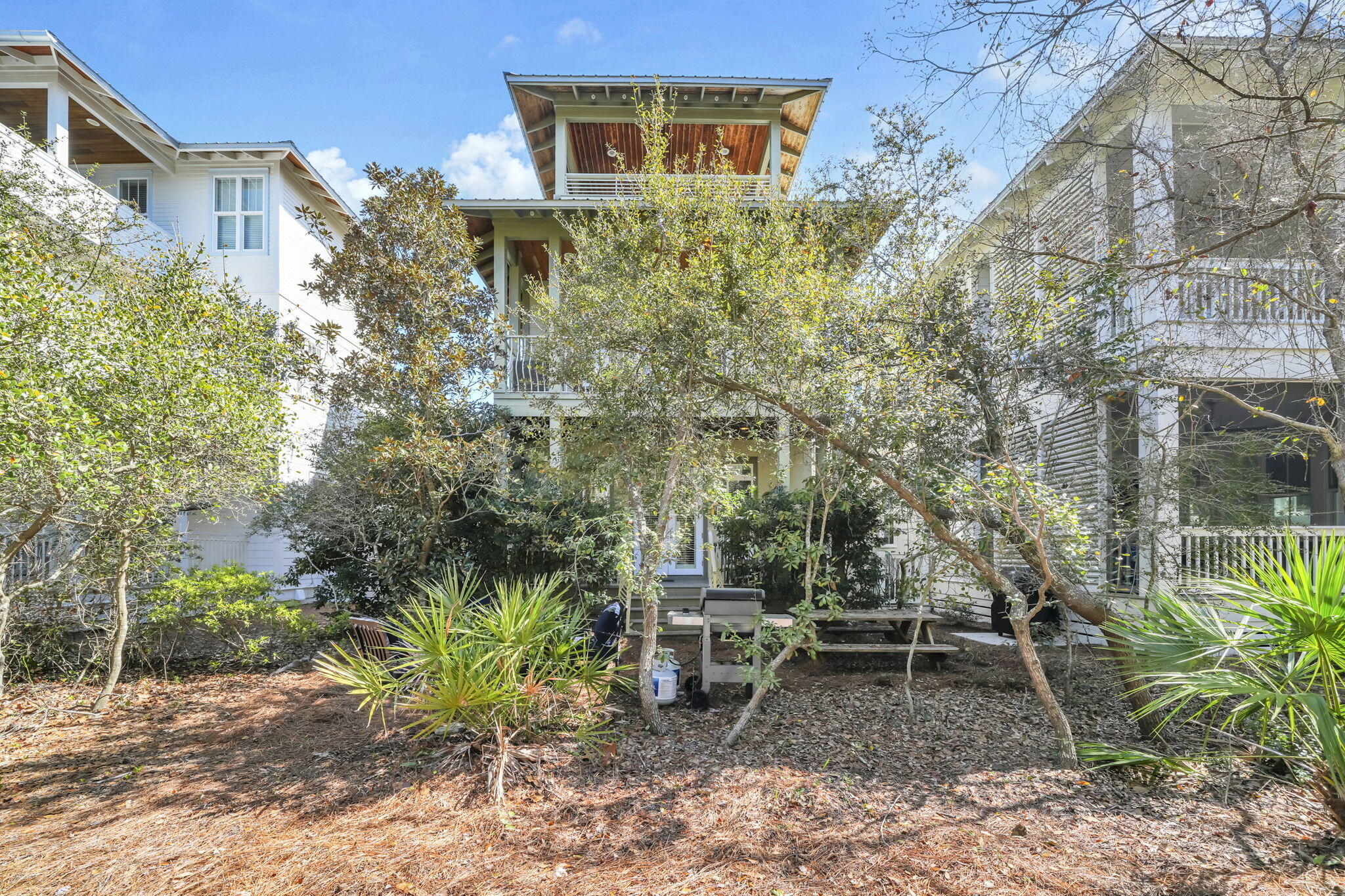 48 Cast Net Lane Seacrest, FL 32461 - Photo 37 of 41 a backyard of a house with table and chairs