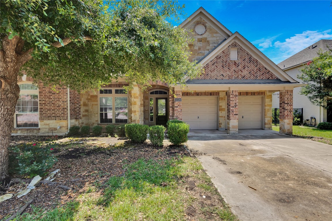 11320 Runnel Ridge Road Manor, TX 78653 - Photo 1 of 1 a front view of a house with a yard
