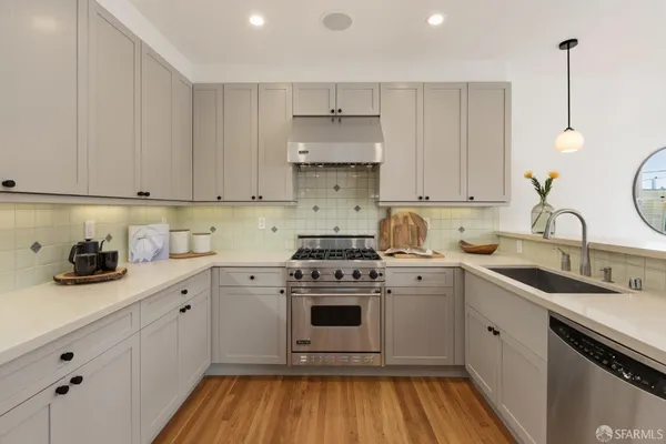 a kitchen with a sink stove and cabinets