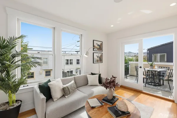 a living room with furniture dining table and a large window