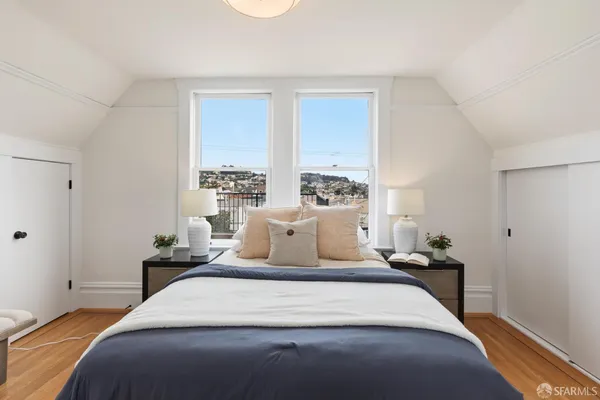 a bedroom with a large bed and a large window