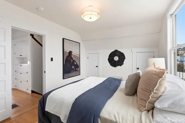 a bedroom with a bed and a window