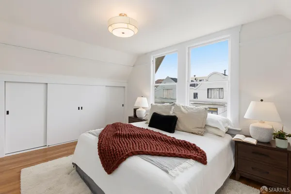 a bedroom with a bed and window