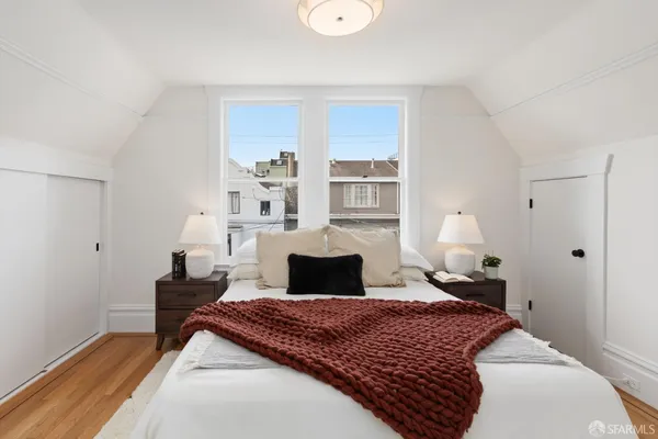 a bedroom with a bed and window