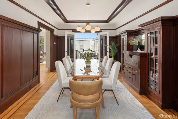 a dining room with furniture a chandelier and window