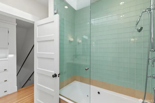a bathroom with a bathtub and a shower
